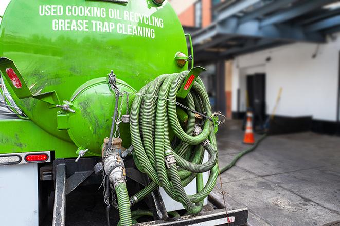 a pump truck emptying a grease trap in Addison, TX